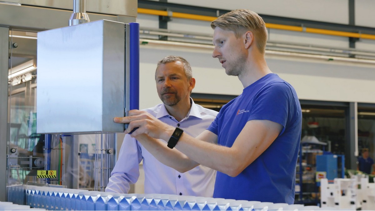 Tronrud Packaging team inspecting a packaging machine during assembly.
