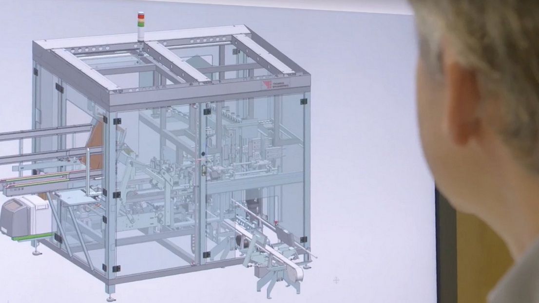 Tronrud Packaging engineer studying machine details on a monitor.