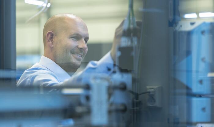 Man inspecting secondary packaging production unit.